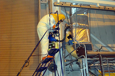 An operator inside the former fuel receiving and storage facility at the West Valley Demonstration Project Site pumps