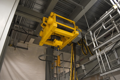 A 10-ton transfer hoist, located in the Hanford Site’s Low-Activity Waste Facility, is a key component in moving containers filled with treated tank waste. During operations, the remotely operated hoist will function behind a shield door. Image: govdelivery.com