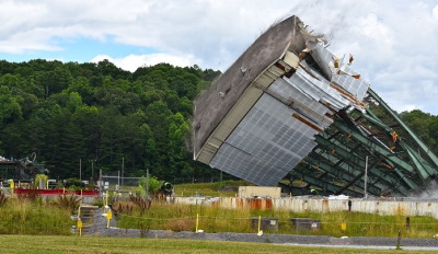 Crews use large winches to tear down a 180-foot tower of the Centrifuge Complex at Oak Ridge. Image: govdelivery.com