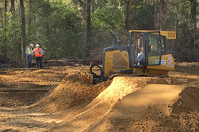 Savannah River Nuclear Solutions engineers Justin Fuller, left, and Steve Conner evaluate progress in the cleanup of a pond-like basin containing low levels of herbicides and pesticides at the Savannah River Site